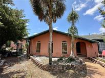 Charming home featuring a brick facade, arched windows, and mature palm trees in the front yard at 300 Broadview Ave, Altamonte Springs, FL 32701