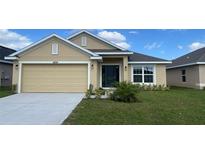 Charming single-story home featuring a manicured lawn and a two-car garage at 4224 Sagefield Dr, Harmony, FL 34773