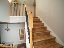 Elegant staircase with wooden steps and iron railing leading to the upper level at 11742 Chateaubriand Ave, Orlando, FL 32836