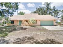 Charming single-story home with a two-car garage, stone accents, and well-manicured lawn at 12454 S Lake Mary Jane Rd, Orlando, FL 32832