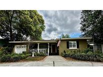 Charming single-story home with a brick walkway, covered porch, and well-maintained landscaping at 1399 Aloma Ave, Winter Park, FL 32789