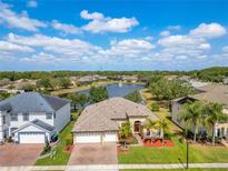 Beautiful home with a three-car garage in a community featuring a tranquil lake and fountain at 16313 Birchwood Way, Orlando, FL 32828