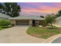 Charming single-story home featuring a well-maintained lawn and a two-car garage at 21529 Prince Albert Ct, Leesburg, FL 34748