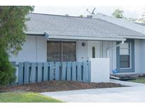 Charming single-story home with a gray roof and a small, fenced front yard at 3154 Stonecastle Rd, Orlando, FL 32822