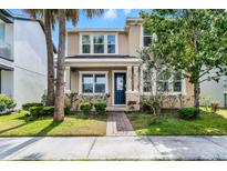 Charming two-story home with lush landscaping and a welcoming brick pathway at 8554 Tallfield Ave, Orlando, FL 32832