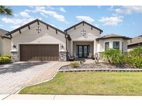 Charming single-story home featuring a brick driveway, two-car garage, and a beautifully landscaped front yard at 1265 Zeek Ridge St, Clermont, FL 34715