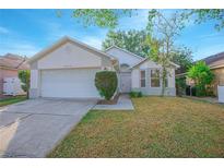 Charming single-story home with a two-car garage and well-maintained front yard at 13216 Wild Duck Ct, Orlando, FL 32828