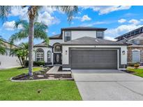 Beautiful two-story home with manicured lawn and landscaping plus a two car garage at 13430 Early Frost Cir, Orlando, FL 32828