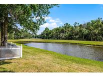 Scenic view of a lush golf course with a pond and mature trees, enhancing the property's appeal at 1527 Braewick St, Winter Springs, FL 32708