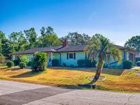 Charming single-story home with a well-maintained lawn, mature landscaping, and a classic exterior at 1872 N Akron Dr, Deltona, FL 32738