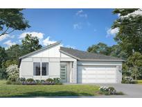 Charming single-story home featuring a modern design, complemented by a well-manicured lawn and colorful landscaping at 2013 Stone Wall Ct, Lake Hamilton, FL 33851
