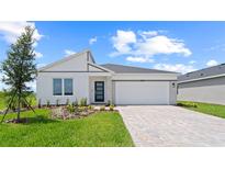 Inviting single-Gathering home featuring a two-car garage, well-manicured lawn, and stylish modern design at 2013 Stone Wall Ct, Lake Hamilton, FL 33851