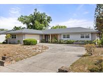 Charming single-story home with a well-maintained lawn and a large, inviting driveway at 2138 Whitehall Dr, Winter Park, FL 32792