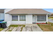 Charming home featuring white stucco, neutral roof, tidy front yard, and welcome decor at 2803 Charing Cross Way, Orlando, FL 32837
