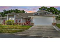 Charming single-story home with well-maintained landscaping and an attached two-car garage at 3137 Timucua Cir, Orlando, FL 32837