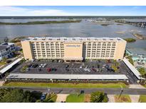 An impressive building featuring multiple levels, parking, and beautiful water views in the backdrop at 3606 S Peninsula Dr # 707, Port Orange, FL 32127