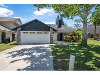 Charming single-Gathering home with a two-car garage, stone accents, and a well-maintained lawn at 3889 Biscayne Dr, Winter Springs, FL 32708
