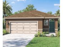 Charming single-story home featuring a two-car garage, dark green front door, and well-manicured landscaping at 4618 Barberry Ave, Lakeland, FL 33811