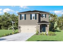 Inviting two-story home features a two car garage, stone accents, and a well manicured front yard at 4622 Barberry Ave, Lakeland, FL 33811