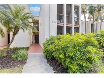 Inviting two-story condo featuring a well-manicured front yard with lush landscaping and a clearly marked address at 516 Orange Dr # 22, Altamonte Springs, FL 32701