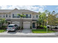 Charming townhouse showcasing a well-maintained lawn and neatly paved driveway, adding to its curb appeal at 561 Pinebranch Cir, Winter Springs, FL 32708
