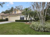 Charming townhome with a well-maintained lawn, featuring mature palms and beautiful landscaping at 688 W Cranes Cir, Altamonte Springs, FL 32701