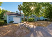 Charming two-story home with a well-manicured lawn and attached garage at 702 Glasgow Ct, Winter Springs, FL 32708