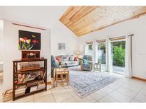 Bright living room with natural light, vaulted ceilings, and tiled floors at 702 Glasgow Ct, Winter Springs, FL 32708