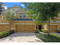 Charming townhouse with a two-car garage, well-maintained landscaping, and a welcoming entryway at 8031 Enchantment Dr # Ge, Windermere, FL 34786