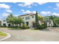 Inviting two-story home featuring a tile roof, stucco exterior, and well-manicured landscaping at 9730 Lounsberry Cir, Golden Oak, FL 32836