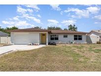 Charming single-story home with a light-colored exterior, yellow door, and attached one car garage at 1037 Abagail Dr, Deltona, FL 32725