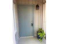 Stylish gray front door featuring a keypad lock and decorative plants, enhancing curb appeal at 112 Crown Oaks Way # 112, Longwood, FL 32779