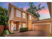 Two-story home with brick driveway, stucco exterior, and well-maintained landscaping at 1130 Hardy Ave, Orlando, FL 32803