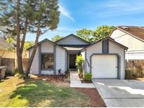 Charming single-story home with well-manicured lawn and attached garage at 1240 Pin Oak Dr, Apopka, FL 32703