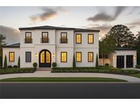 Stunning two-story home with a modern design, beautiful landscaping, and a grand entrance at 185 Sylvan Blvd, Winter Park, FL 32789