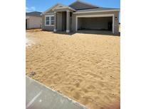 Single Gathering home featuring an open garage and neutral color palette in a developing community at 2009 Stone Wall Ct, Lake Hamilton, FL 33851