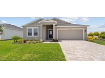Charming single-Gathering home with well-manicured lawn, lovely landscaping and a two-car garage at 2009 Stone Wall Ct, Lake Hamilton, FL 33851