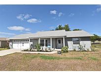 Charming single-story home with a well-manicured lawn and lovely landscaping, perfect curb appeal at 2102 Urbana Ave, Deltona, FL 32725
