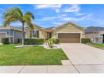 Charming single-Gathering home with a well-manicured lawn, lush landscaping, and a two-car garage at 2815 Shelburne Way, St Cloud, FL 34772