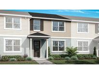 Charming new two-story townhome featuring a welcoming front porch and landscaped yard at 2831 Camellia Flower St, Apopka, FL 32703