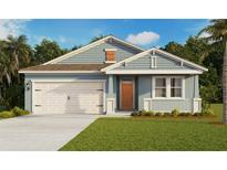 Charming single-story home with a two-car garage, light blue siding, and a well-manicured front lawn at 5420 Cloudberry Ave, Lakeland, FL 33811