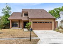 Charming home featuring a two-car garage, well-maintained landscaping and neutral stucco exterior at 1103 Saddleback Ridge Rd, Apopka, FL 32703