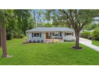 Charming single-story home with a well-manicured lawn and inviting front porch at 1121 Magnolia Ave, Daytona Beach, FL 32114