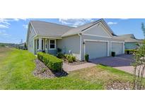Beautiful home with a two-car garage and a well-manicured front yard at 2681 Spider Lily Ct, Clermont, FL 34711