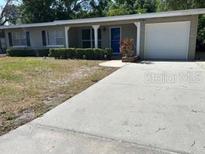 Charming single-story home featuring a well-maintained lawn, covered porch and a convenient attached garage at 2886 Carew Ave, Winter Park, FL 32789