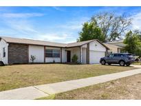 Charming single-story home featuring a well-maintained lawn and an attached garage at 3041 Dikewood Ct, Winter Park, FL 32792