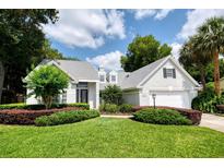 Beautifully landscaped, two-story home with a well-manicured lawn and lovely curb appeal at 308 Pine Shadow Ln, Lake Mary, FL 32746