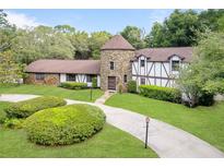 Stunning home featuring a stone turret, manicured landscaping, and a charming walkway at 3420 Dawn Ct, Lake Mary, FL 32746