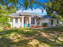 Charming single-story home featuring manicured landscaping, a well-maintained lawn, and a welcoming front entrance at 38241 County Road 439, Eustis, FL 32736