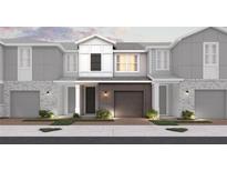 New construction townhomes featuring brick and modern grey siding, attached garages, and manicured landscaping at 555 Southern Edge Way, Sanford, FL 32771